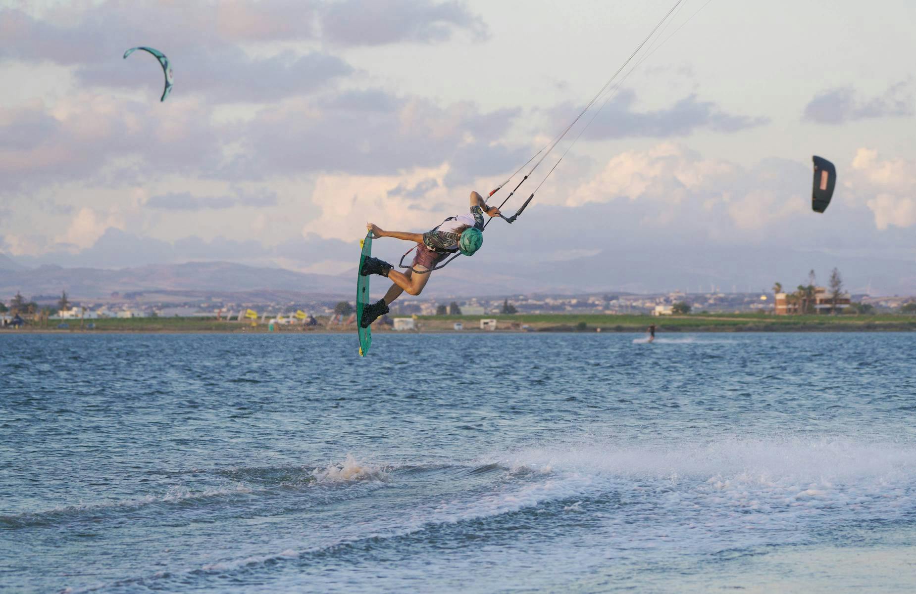 kitesurfer performing a tail grab in Lo Stagnone lagoon