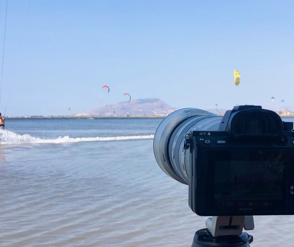 camera with kitesurfing spot in the background